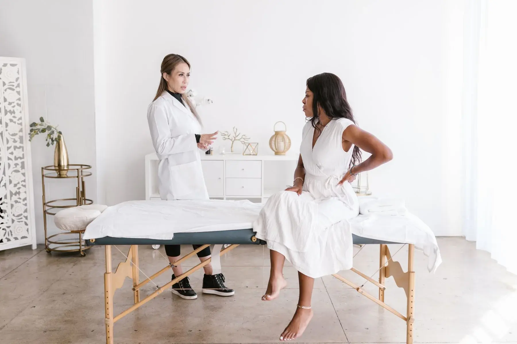 A healthcare professional talking with a patient in a medical setting